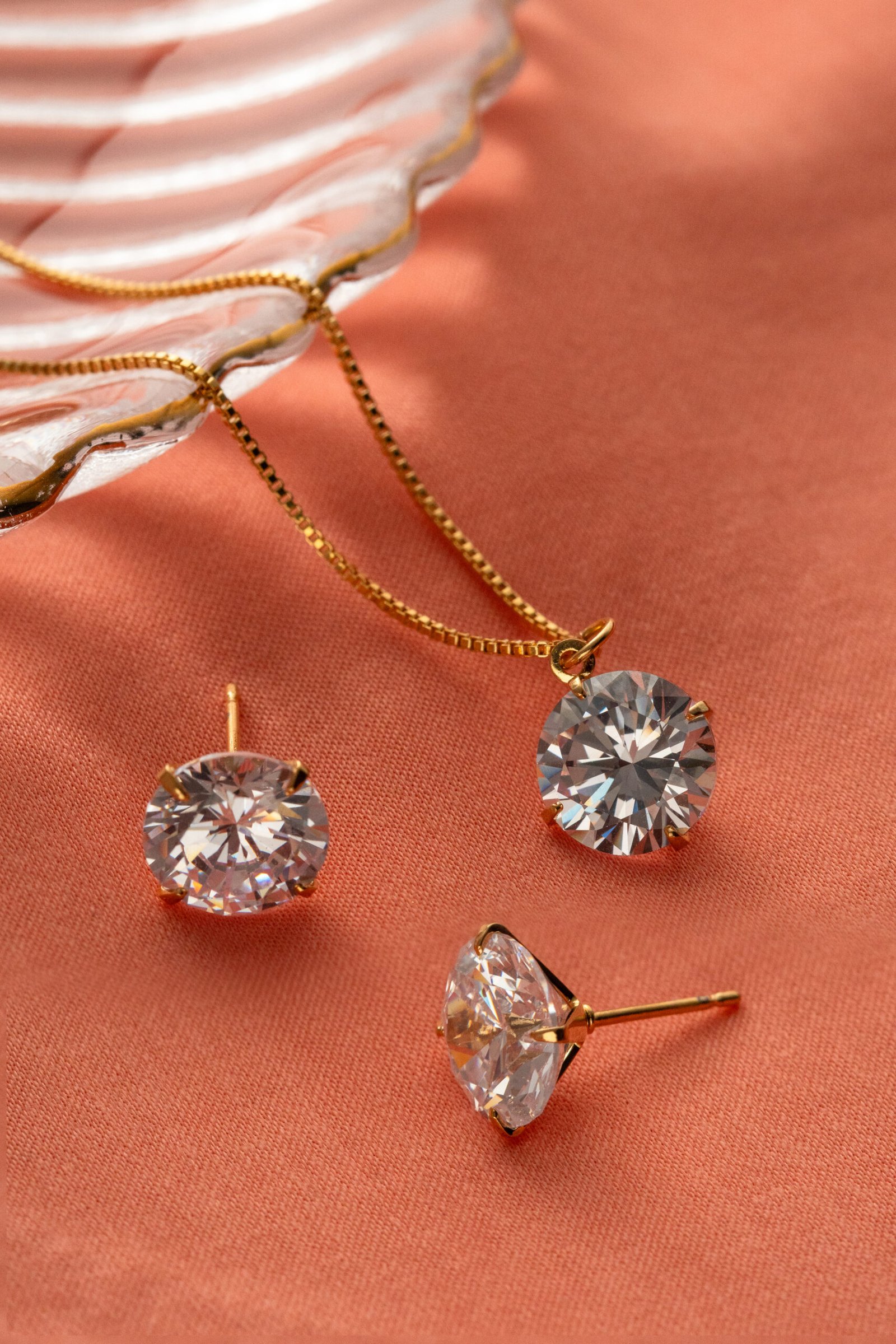 Descubra a beleza atemporal do Conjunto de Colar e Brincos Ponto de Luz Com Banho em Ouro 18k. Este conjunto encantador apresenta um design simples e elegante, com pontos de luz brilhantes que capturam a luz de forma deslumbrante. O acabamento com Banho em Banho em Ouro 18k, adiciona um toque de luxo, tornando este conjunto perfeito para qualquer ocasião. Seja para uso diário ou para uma ocasião especial, este conjunto irradia elegância e sofisticação.